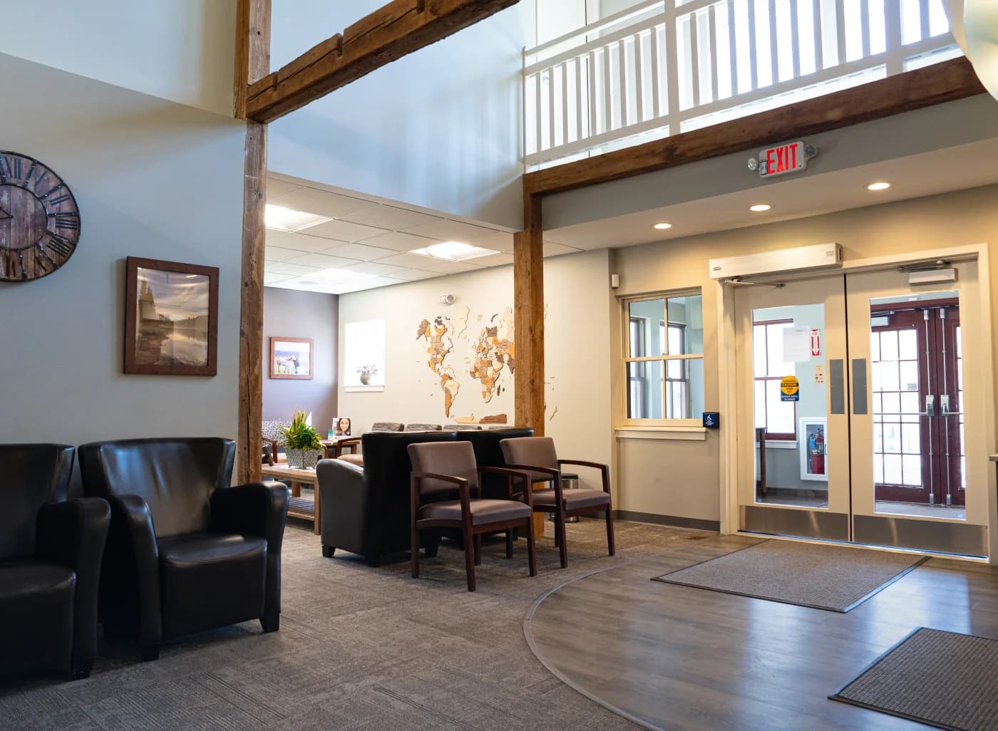 Welcoming reception area with seating and wooden world map