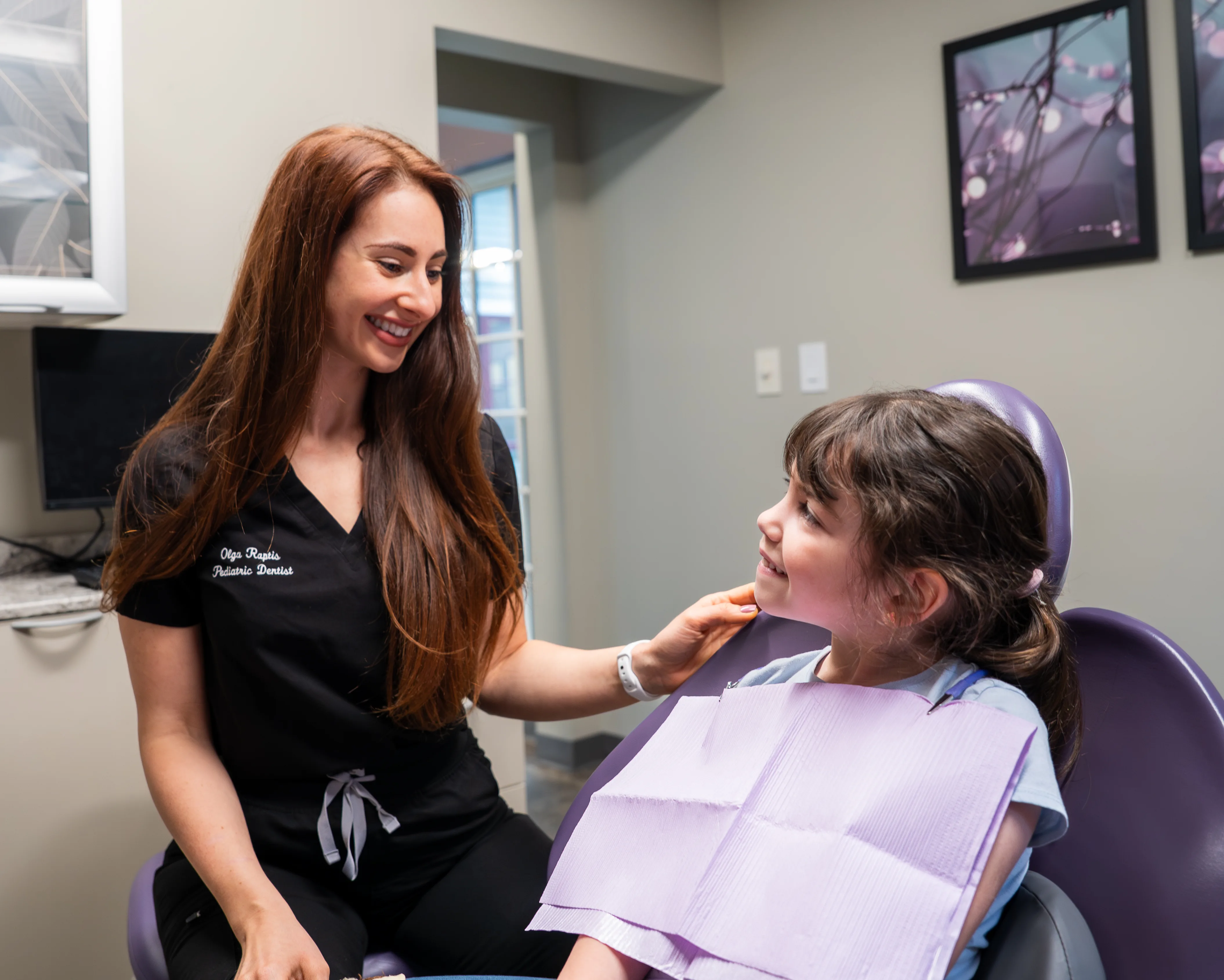 Pediatric dentist speaking with a young patient during a comfortable dental visit at Atlas Dental.