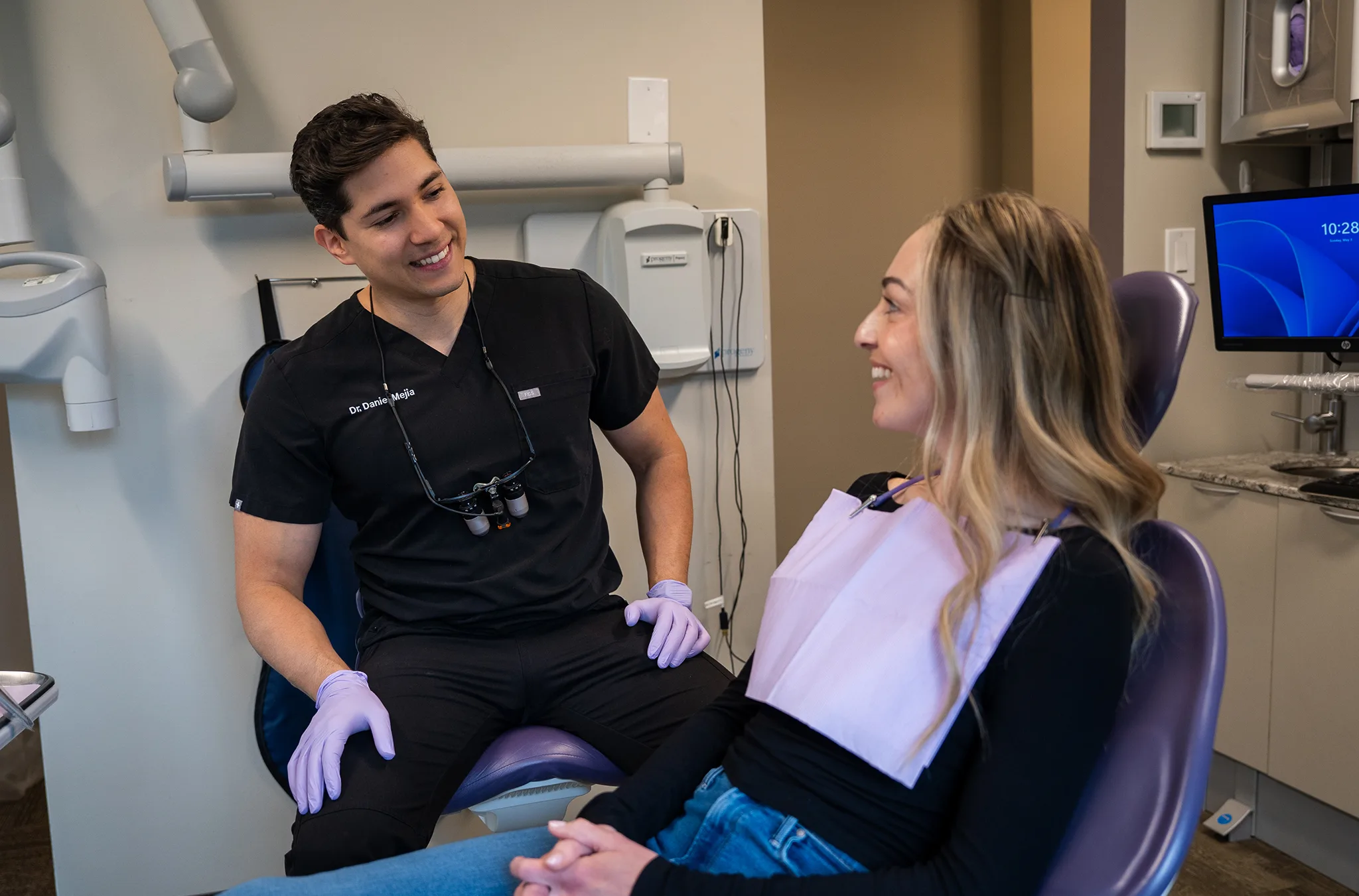 Dentist consulting with a patient in a modern Atlas Dental treatment room.